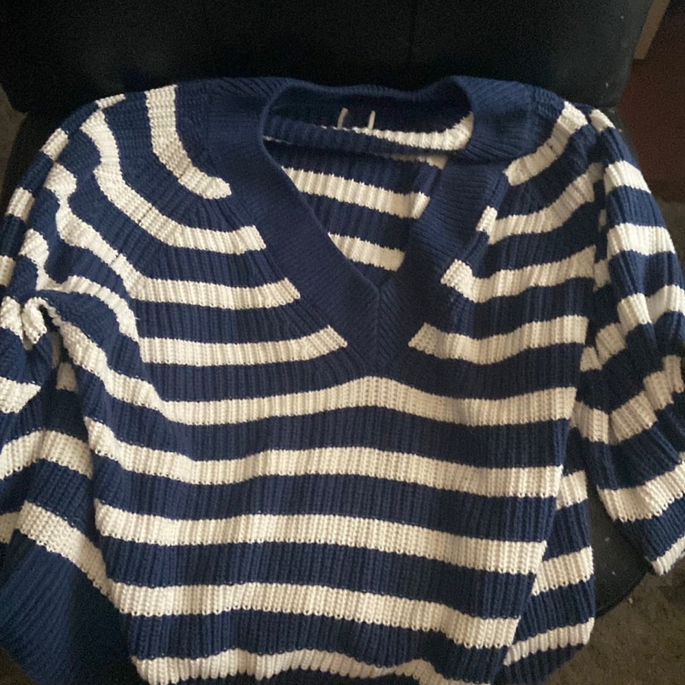 A striped white and navy sweater size is 3x and it is in good condition